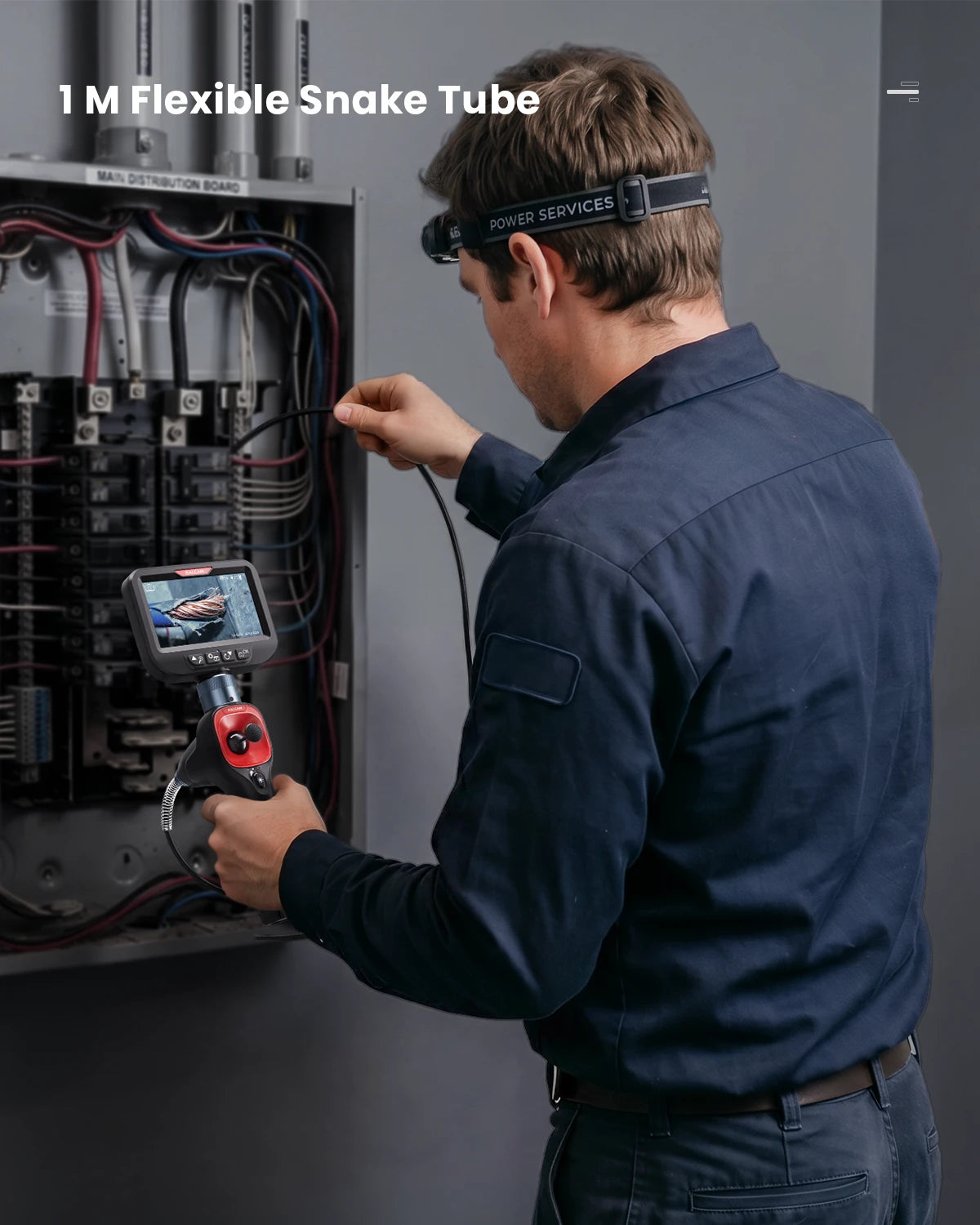 Flexible snake tube feeding into an electrical distribution board during a live inspection