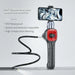 4-way articulating borescope with flexible black cable and smartphone showing engine gears, waterproof and phone compatible